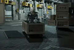 Robot steps out of a box in a warehouse