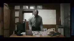 Man throws photos on desk in frustration