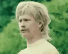 Man with mustache looking around confused