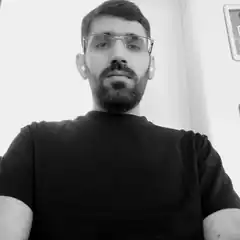 Man with glasses and beard looking at camera