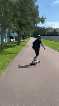 Two people longboarding on a path