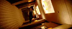 Man running down hotel hallway