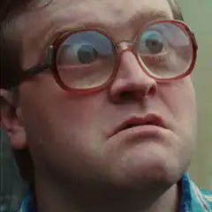 Man with thick glasses looking confused