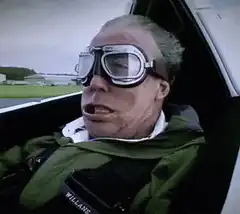 Michael Caine in a plane with goggles