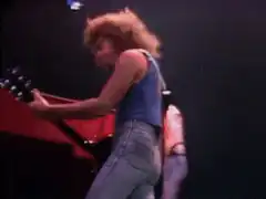 Guitarist smashing guitar on stage
