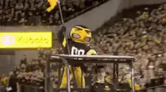 Bucky Badger waving flag at game