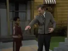 Mr. Rogers and a child high five