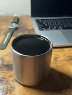 steaming metal coffee cup on desk
