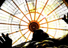 Statue under glass dome with hands up