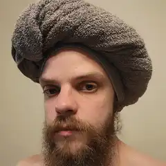 Man with towel on head shoots laser eyes