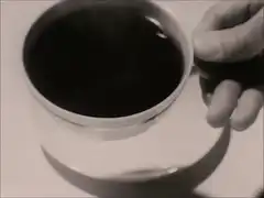 Hand holding cup of black coffee