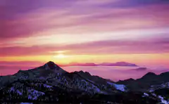 sunset over snowy mountains