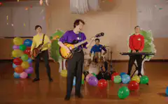 Band playing with confetti and balloons