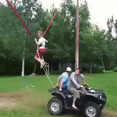 Man on bungee cord pulled by ATV