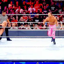 Wrestler in pink pants does a handstand