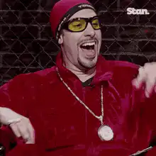 Man in red outfit laughing