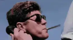 man smoking cigar on phone