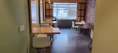 Modern cafe interior with wooden tables and brick wall