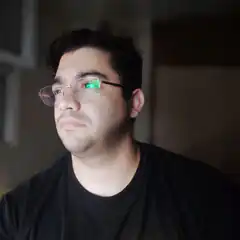 Man with green screen reflection in glasses