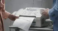 Office worker reads fax and reacts