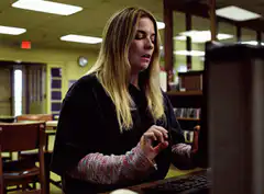 Woman typing on keyboard in library