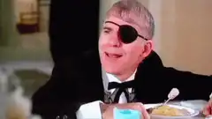 Steve Martin with eyepatch eating