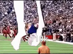 Shirtless man jumps over cheerleaders
