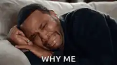 Man crying on couch WHY ME