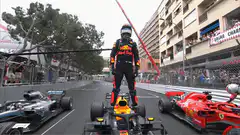 Max Verstappen standing on Red Bull car