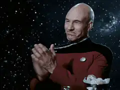 Captain Picard clapping with a smirk