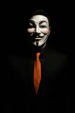 Guy Fawkes mask with orange tie