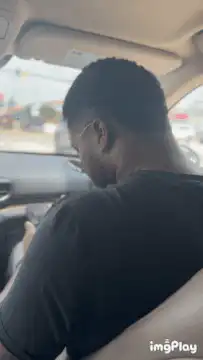 Man in car looks back suspiciously