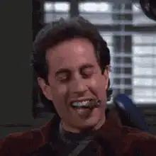 Jerry Seinfeld laughing with a cigar