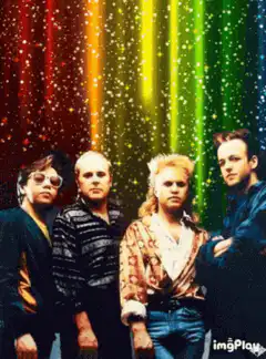 Four men standing in front of a rainbow background
