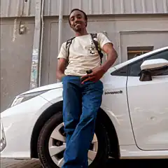 Man leaning on white car