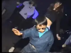 Kid dancing in sunglasses at club