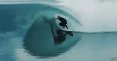 Surfer riding inside a barrel wave