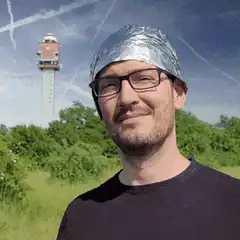 Man in foil hat with radiation tower