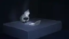 cat typing on laptop in dark