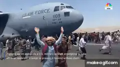 Afghans sprint alongside U.S. Air Force plane