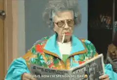 Betty White reading newspaper with cigarette