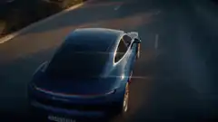 Blue Tesla driving on road
