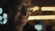 Man in glasses smiling and laughing