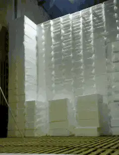 Man stacking white styrofoam blocks