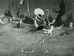 Skeleton dancing in graveyard