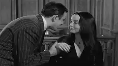 Gomez kisses Morticia's hand