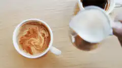 Pouring milk into coffee