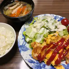 Japanese meal with rice, soup, salad, and omelet