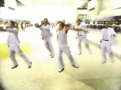men in white dancing in airport