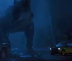 T-Rex roaring at a car in the rain